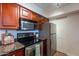 Efficient kitchen with stainless steel appliances, dark cabinets, and plenty of storage space at 5877 N Granite Reef Rd # 1155, Scottsdale, AZ 85250