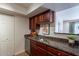 Functional kitchen area with granite countertops, stainless steel sink, and convenient access to adjacent rooms at 5877 N Granite Reef Rd # 1155, Scottsdale, AZ 85250