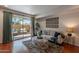 Bright living room features a comfortable sofa, plant accents, and a sliding door leading to an outdoor seating area at 5877 N Granite Reef Rd # 1155, Scottsdale, AZ 85250