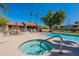 Community pool with a built-in spa next to a charming dining area at 5877 N Granite Reef Rd # 1155, Scottsdale, AZ 85250