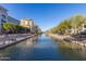 Beautiful waterfront view with picturesque buildings and lush trees at 5877 N Granite Reef Rd # 1155, Scottsdale, AZ 85250