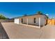 Backyard of the property featuring new gravel and covered patio at 7507 E Beatrice St, Scottsdale, AZ 85257