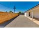 Fenced backyard of the property featuring new gravel and covered patio at 7507 E Beatrice St, Scottsdale, AZ 85257