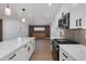 Open floor plan featuring a kitchen island with marble countertops and adjacent living area with custom cabinets at 7507 E Beatrice St, Scottsdale, AZ 85257