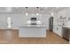 Modern kitchen featuring white cabinets, stainless steel appliances, and a center island with countertop seating at 7507 E Beatrice St, Scottsdale, AZ 85257