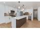 Stylish kitchen featuring white cabinets, stainless steel appliances, and a central island with unique wood accents at 7507 E Beatrice St, Scottsdale, AZ 85257