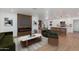 Bright, open living room featuring a modern fireplace, hardwood floors, and a seamless flow to the kitchen at 7507 E Beatrice St, Scottsdale, AZ 85257