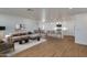 Bright and open living area with modern furnishings, seamlessly connected to the dining and kitchen spaces at 7507 E Beatrice St, Scottsdale, AZ 85257