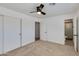 Bright main bedroom features a ceiling fan, neutral carpet, and ensuite bathroom at 7507 E Beatrice St, Scottsdale, AZ 85257