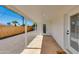 Covered patio area with a concrete floor, white support beams, and access to a fenced yard at 7507 E Beatrice St, Scottsdale, AZ 85257