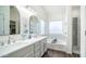 Updated bathroom featuring double sinks, quartz countertop, soaking tub, and a glass-enclosed shower at 843 W Palo Verde St, Gilbert, AZ 85233