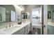 Clean and modern bathroom with double sinks, white countertops, and tile floors at 843 W Palo Verde St, Gilbert, AZ 85233