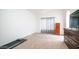 Minimalist bedroom with carpeted floor and dark-wood chest of drawers, illuminated by natural light at 843 W Palo Verde St, Gilbert, AZ 85233