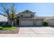 Exterior view of the two-story home shows mature trees and a spacious driveway at 843 W Palo Verde St, Gilbert, AZ 85233