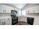 Bright kitchen featuring white cabinets, quartz countertops, and sleek appliances, offering both style and functionality at 843 W Palo Verde St, Gilbert, AZ 85233