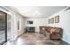 Cozy living room featuring a comfortable leather sofa, entertainment center, and sliding glass doors at 843 W Palo Verde St, Gilbert, AZ 85233