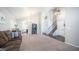 Open-concept living room with plush carpet, high ceilings, and seamless transition to the staircase at 843 W Palo Verde St, Gilbert, AZ 85233