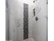 Modern shower with white marble tile, a mosaic stripe, and recessed shelving niche at 843 W Palo Verde St, Gilbert, AZ 85233