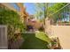 Private backyard with artificial turf, potted flowers, grill, and space for outdoor dining at 9070 E Gary Rd # 136, Scottsdale, AZ 85260