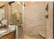 Tiled bathroom with a glass shower, granite countertops, and a dark wood vanity at 9070 E Gary Rd # 136, Scottsdale, AZ 85260