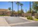 Gated community entrance with lush landscaping and mature palm trees providing a secure and welcoming entry at 9070 E Gary Rd # 136, Scottsdale, AZ 85260