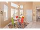 Dining room with glass table, colorful chairs, and lots of natural light from large windows at 9070 E Gary Rd # 136, Scottsdale, AZ 85260