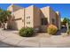 Beige modern home with a two-car garage, desert landscaping, and turquoise trimmed windows at 9070 E Gary Rd # 136, Scottsdale, AZ 85260