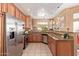 Eat-in kitchen with stainless steel appliances, granite countertops, and light brown cabinetry at 9070 E Gary Rd # 136, Scottsdale, AZ 85260