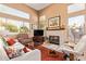 Living room with a fireplace, large windows, high ceilings, and a white leather sofa at 9070 E Gary Rd # 136, Scottsdale, AZ 85260