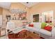 Open concept living room and kitchen with light tile flooring, high ceilings, and white leather furniture at 9070 E Gary Rd # 136, Scottsdale, AZ 85260