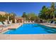 Community pool with lounge chairs, shade structures, and neatly landscaped surroundings at 9070 E Gary Rd # 136, Scottsdale, AZ 85260