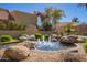 Serene water feature surrounded by rocks and lush landscaping, enhancing the community's ambiance at 9070 E Gary Rd # 136, Scottsdale, AZ 85260