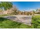 Basketball court in grassy community park offers a place for sports and recreation at 927 W Wendy Way, Gilbert, AZ 85233