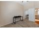 Bedroom with beige walls and carpet has a desk with entry to en-suite bathroom at 927 W Wendy Way, Gilbert, AZ 85233