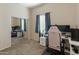 Bedroom with mirrored closet, beige walls and carpet, with desk and chair at 927 W Wendy Way, Gilbert, AZ 85233