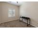 Bedroom with beige walls, a large window and a desk at 927 W Wendy Way, Gilbert, AZ 85233