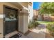 Inviting front door featuring a decorative wreath and a covered entry, complemented by manicured landscaping at 927 W Wendy Way, Gilbert, AZ 85233