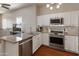 Modern kitchen featuring granite countertops, stainless steel appliances, and white cabinetry with stylish lighting at 927 W Wendy Way, Gilbert, AZ 85233