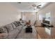 Spacious living room with comfortable sofas, ceiling fan, a stylish rug, and plenty of natural light at 927 W Wendy Way, Gilbert, AZ 85233
