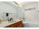 A well-lit bathroom featuring a tub, toilet, vanity, and large mirror at 930 E Citation Ln, Tempe, AZ 85284