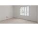 Cozy bedroom featuring a large window, neutral carpeting, and ample natural light at 930 E Citation Ln, Tempe, AZ 85284