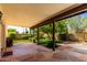 Covered patio with desert landscaping, orange tree, and gas grill, perfect for entertaining at 930 E Citation Ln, Tempe, AZ 85284
