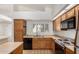 Bright kitchen featuring oak cabinets, tile flooring, stainless steel appliances, and natural light at 930 E Citation Ln, Tempe, AZ 85284