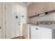 The laundry room has a washer, a dryer, and cabinets at 930 E Citation Ln, Tempe, AZ 85284