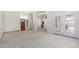 Large, light-filled living room with neutral paint, carpet and multiple access points to other rooms at 930 E Citation Ln, Tempe, AZ 85284