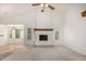 Spacious living room with a white-painted brick fireplace, large windows, and neutral carpet at 930 E Citation Ln, Tempe, AZ 85284