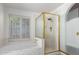 Luxurious bathroom features a gold-trimmed glass shower and separate marble soaking tub at 930 E Citation Ln, Tempe, AZ 85284