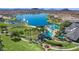 Aerial view of community pool and waterpark area next to a large lake with fountains and lush landscaping at 12733 S 177Th Ln, Goodyear, AZ 85338