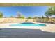 Backyard pool surrounded by mature shrubs and block fencing at 12733 S 177Th Ln, Goodyear, AZ 85338