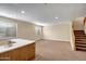 Open basement featuring neutral paint, carpet, windows and a staircase to the upper level at 12733 S 177Th Ln, Goodyear, AZ 85338